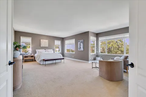 a bedroom with a bed and large window