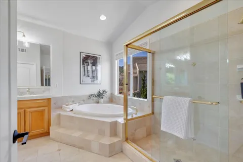a spacious bathroom with sink shower and bathtub