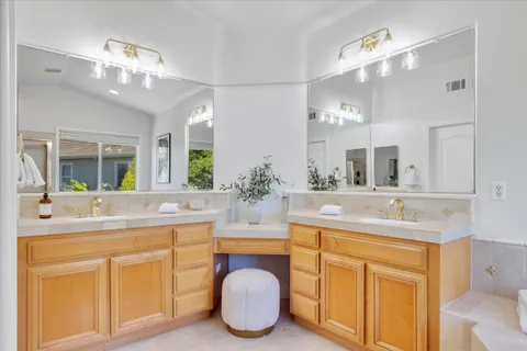 a bathroom with a sink double vanity and a mirror