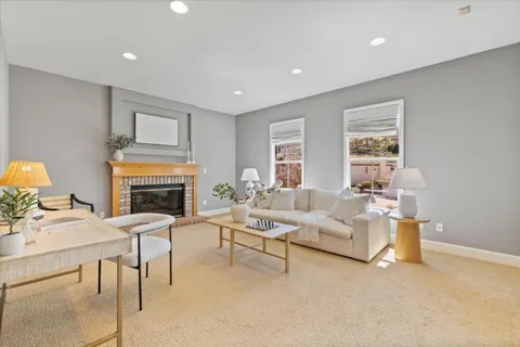 a view of a balcony with furniture and a floor to ceiling window