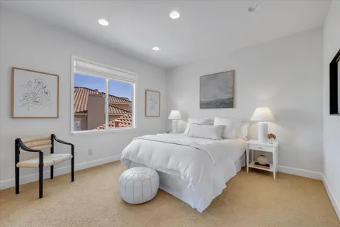 a bedroom with bed and a window