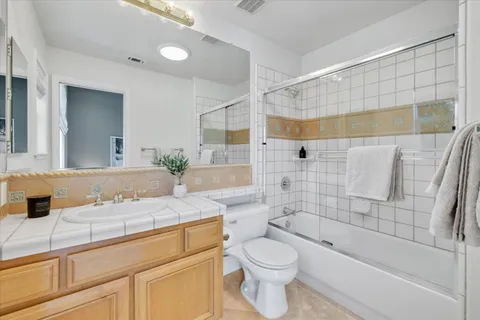 a bathroom with a sink mirror and toilet