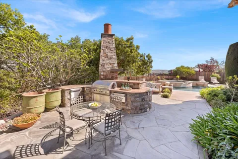 a view of a chairs and table in the patio