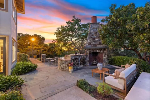 a view of a patio with couches and a table and chairs with potted plants