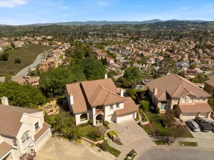 an aerial view of residential house with outdoor space and parking