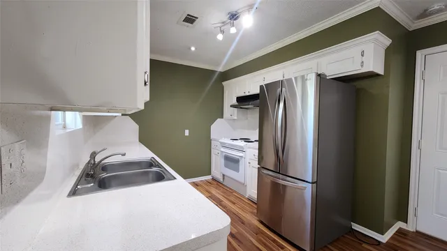 a kitchen with stainless steel appliances a refrigerator and a stove