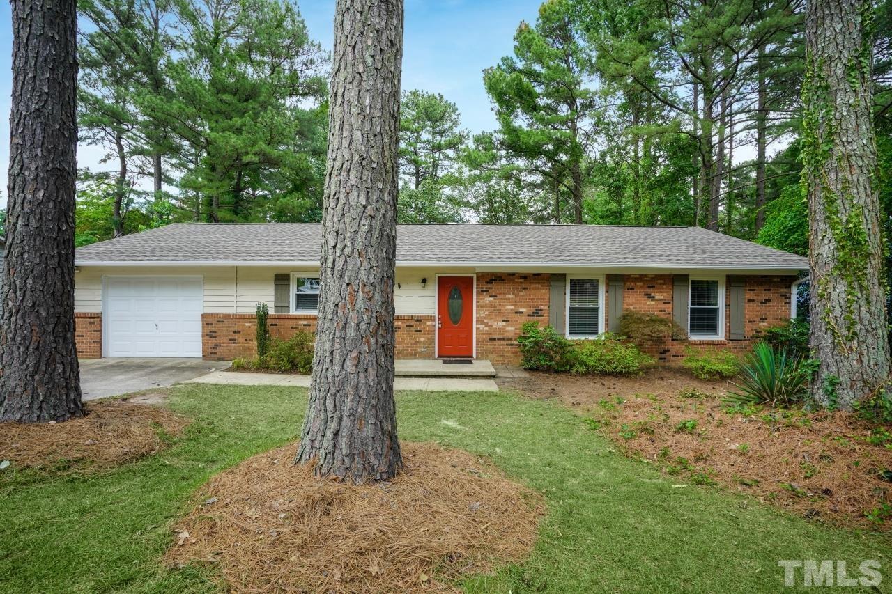 a front view of a house with a yard and porch