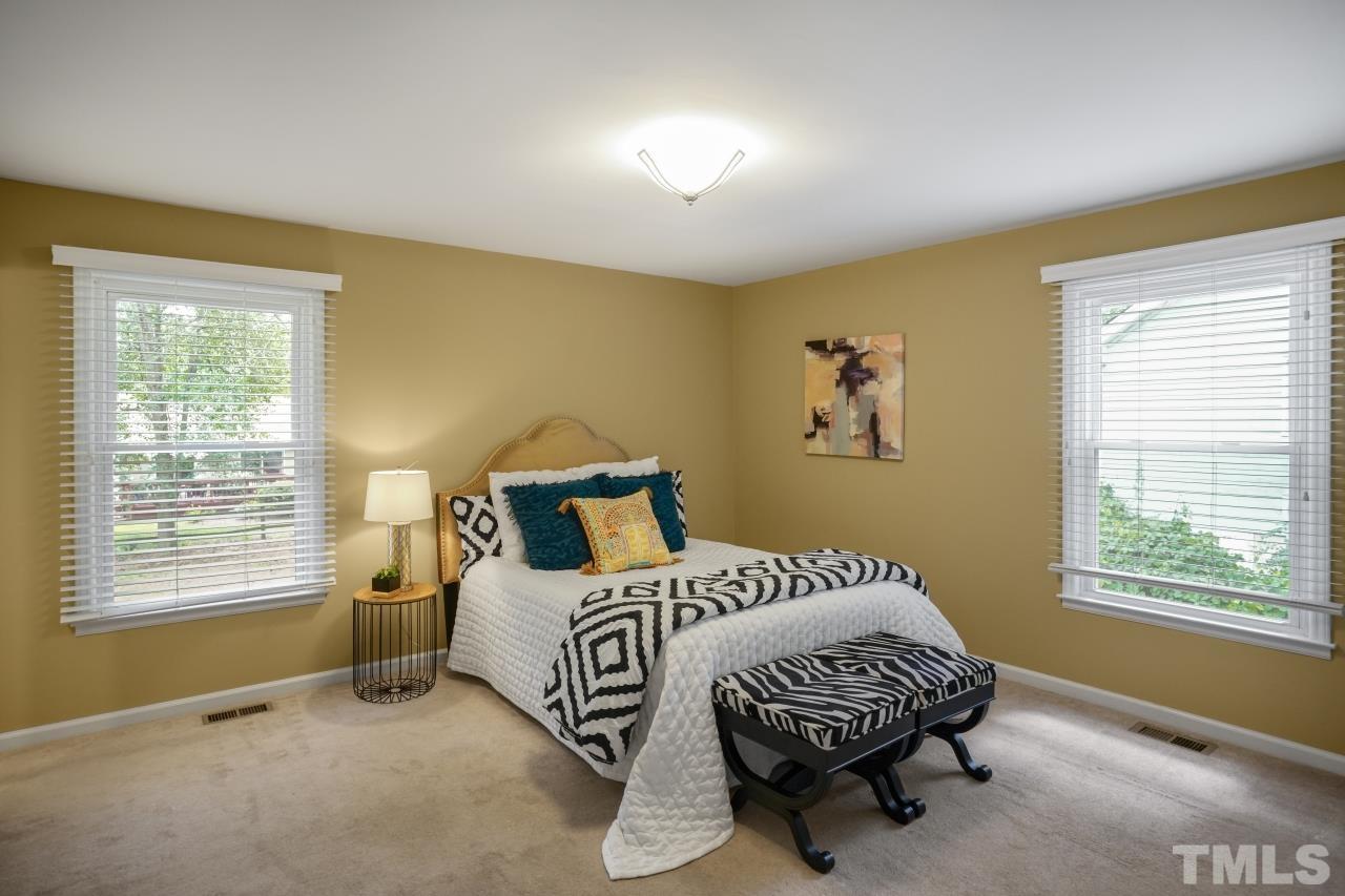 7016 Ray Road Raleigh, NC 27613 - Photo 11 of 26 a bedroom with a bed and a window