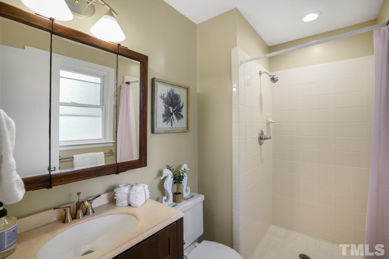 7016 Ray Road Raleigh, NC 27613 - Photo 13 of 26 a bathroom with a sink toilet and shower
