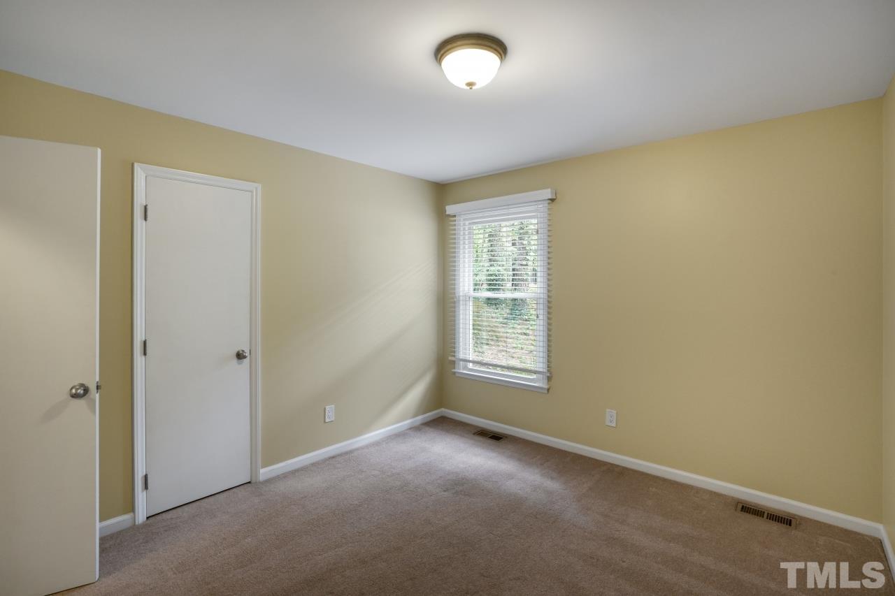 7016 Ray Road Raleigh, NC 27613 - Photo 18 of 26 a view of an empty room with a window