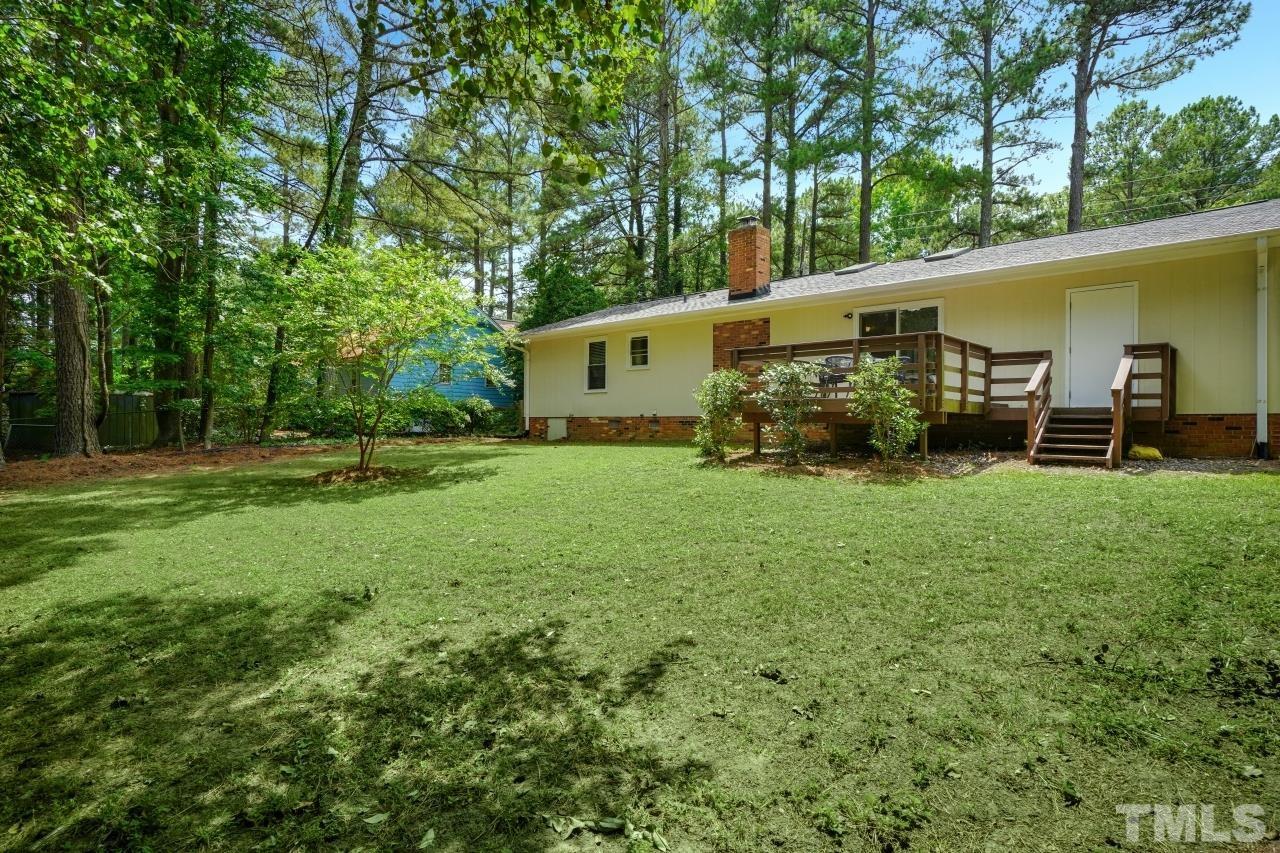 7016 Ray Road Raleigh, NC 27613 - Photo 25 of 26 a backyard of a house with garden and plants