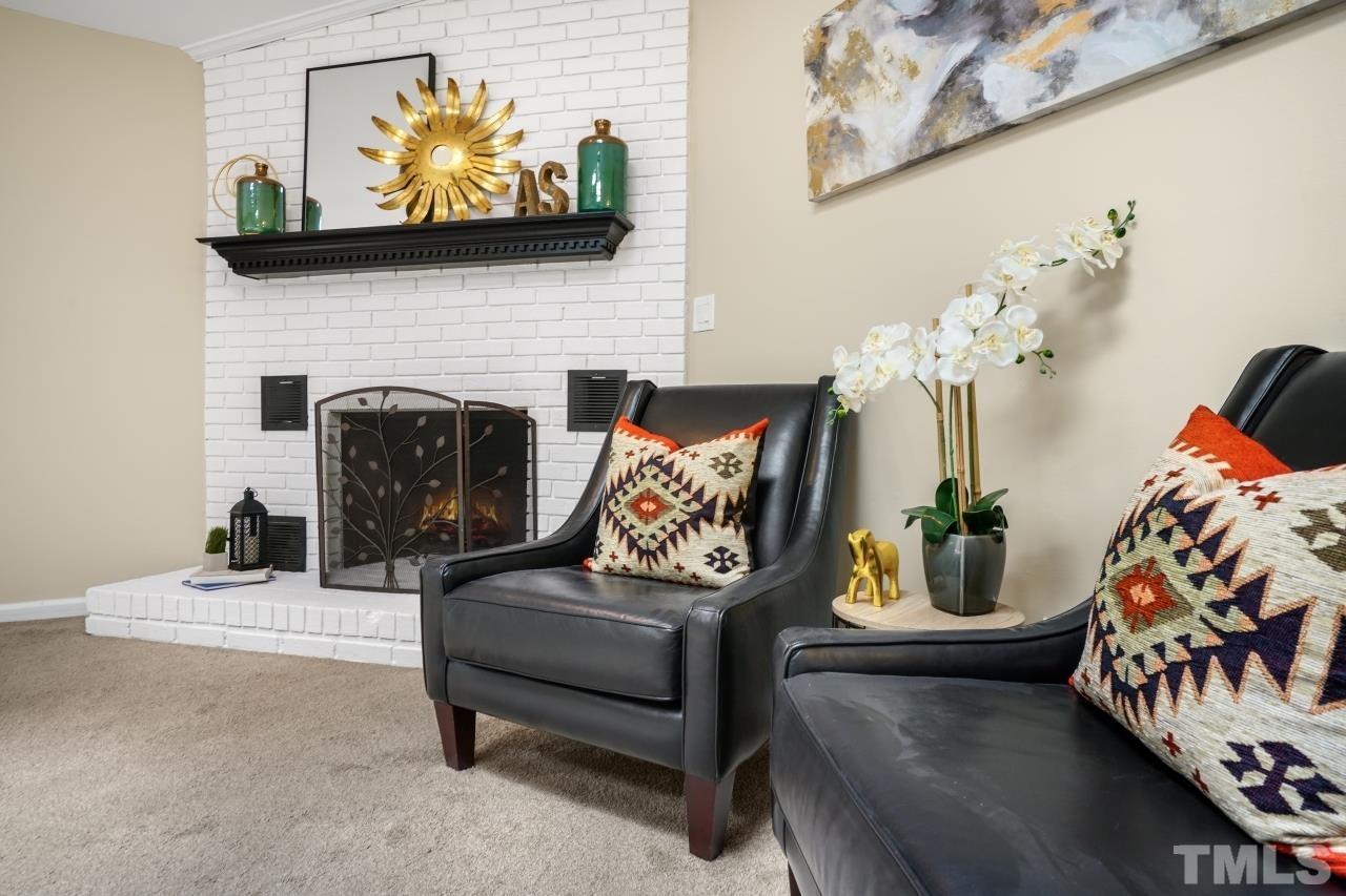 7016 Ray Road Raleigh, NC 27613 - Photo 9 of 26 a living room with furniture and a fireplace