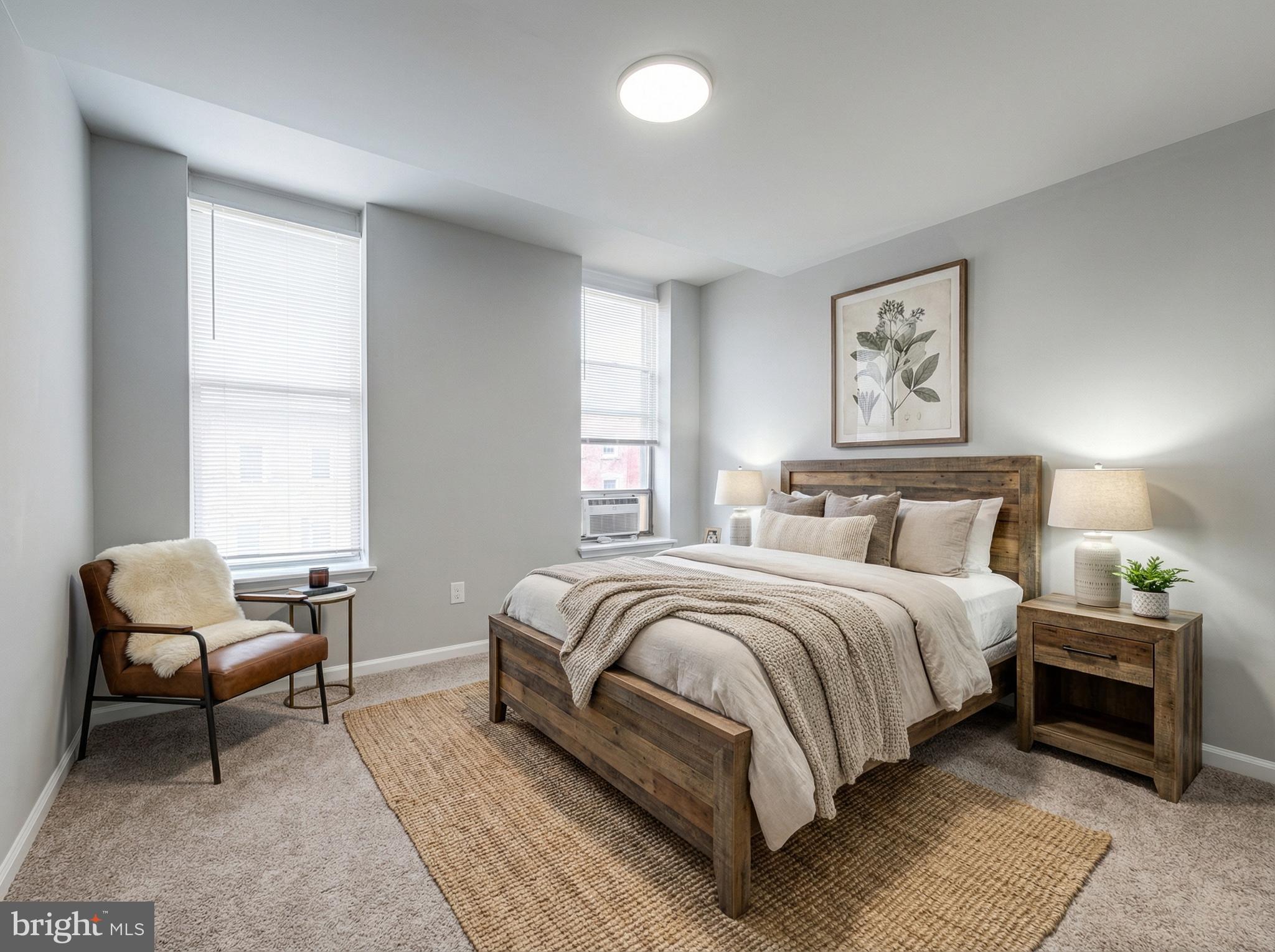 411 North Chester Street Baltimore, MD 21231 - Photo 2 of 22 a bedroom with a bed chairs and painting on the wall