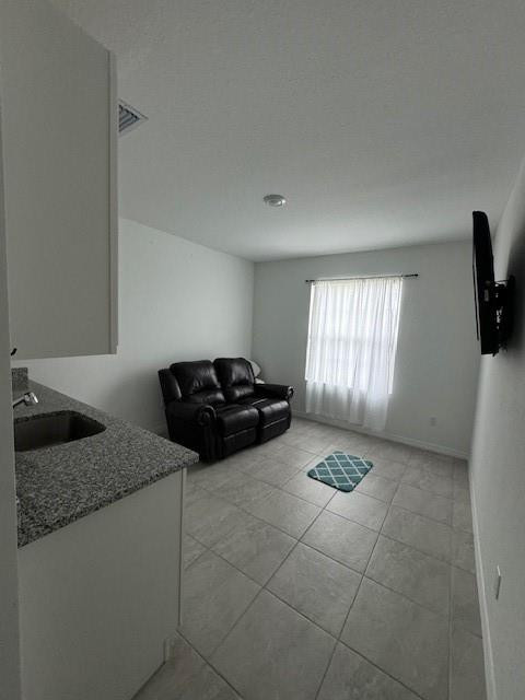 5133 Armina Place, Unit STUDIO Fort Pierce, FL 34951 - Photo 2 of 15 a kitchen with granite countertop a sink a stove and cabinets
