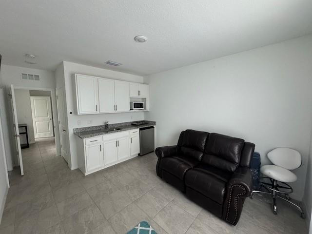 5133 Armina Place, Unit STUDIO Fort Pierce, FL 34951 - Photo 3 of 15 a living room with furniture and a couch