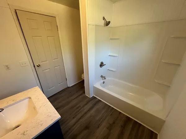 a bathroom with a tub and shower