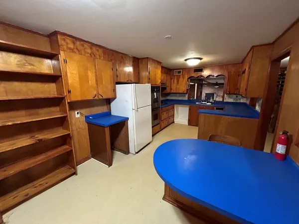 a view of a livingroom with furniture and a kitchen