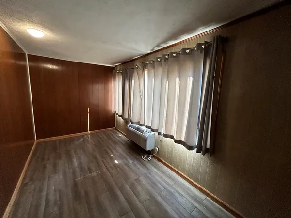 a view of a room with wooden floor and stairs