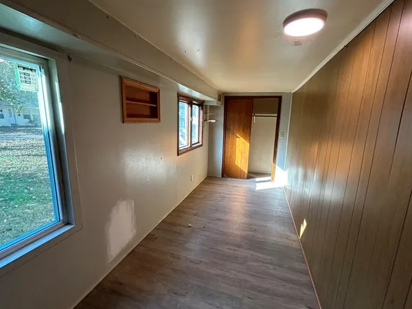 a view of hallway with stairs and wooden floor