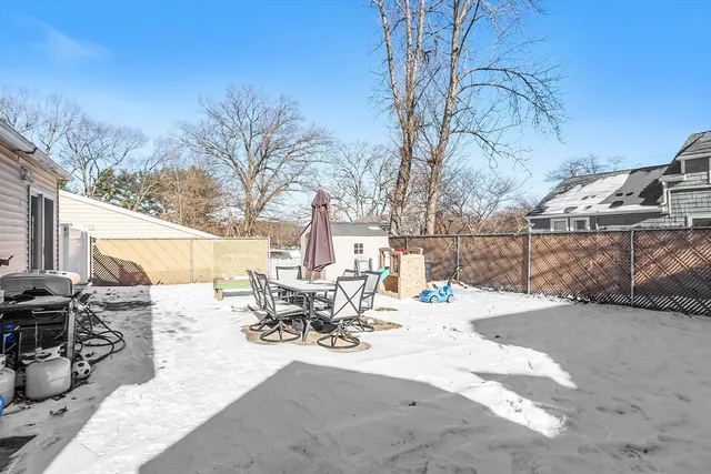 a view of a patio with a table and chairs under an umbrella