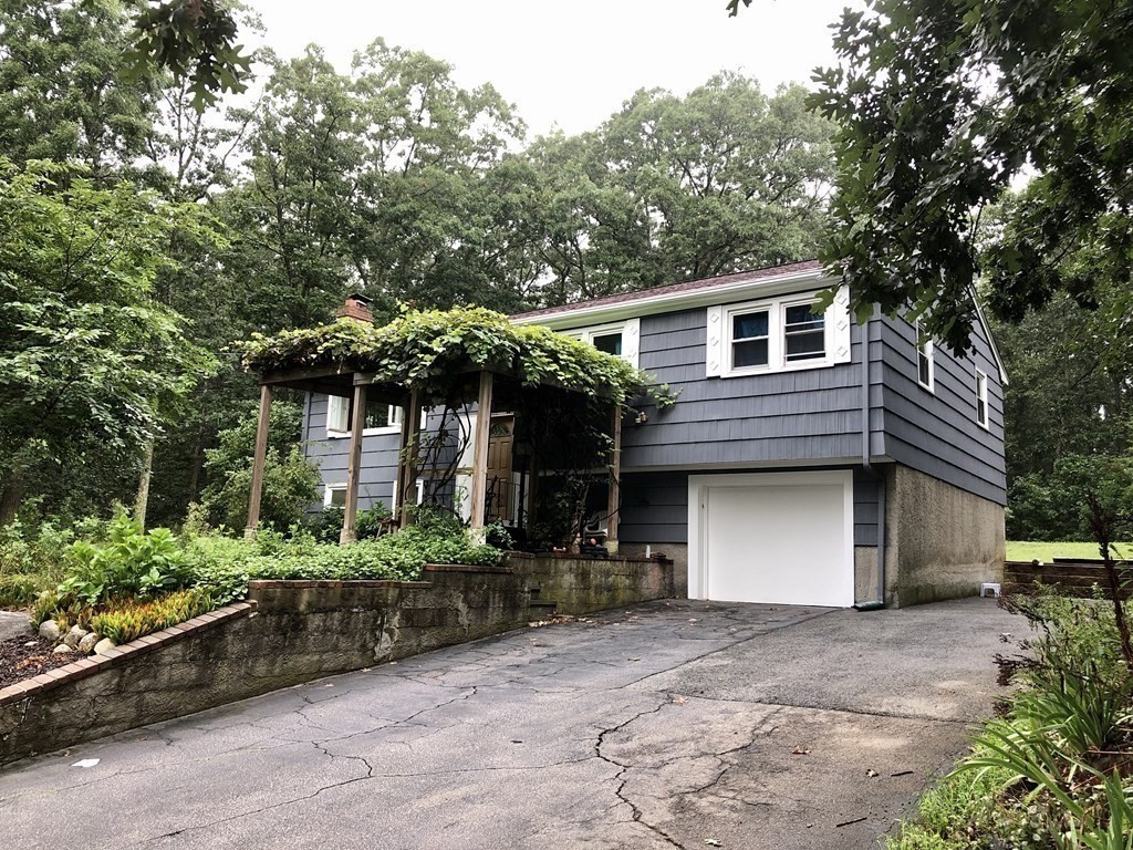 a front view of a house with a yard and a garage