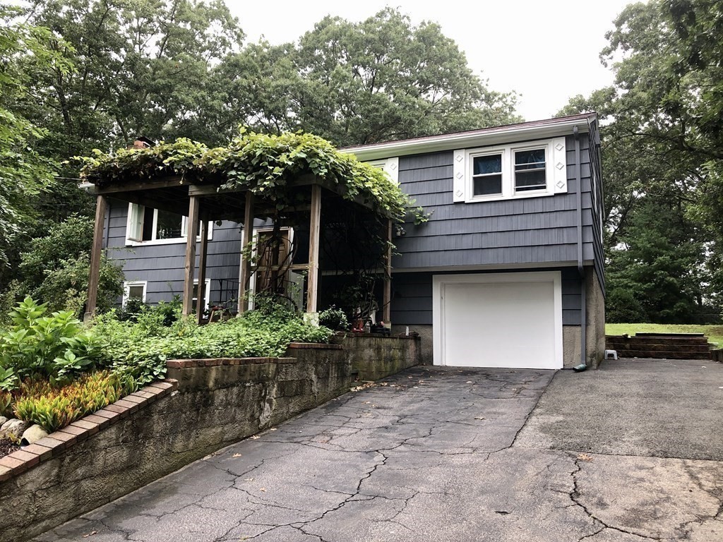 69 Deerfield Road Sharon, MA 02067 - Photo 12 of 12 a front view of a house with a yard and a garage