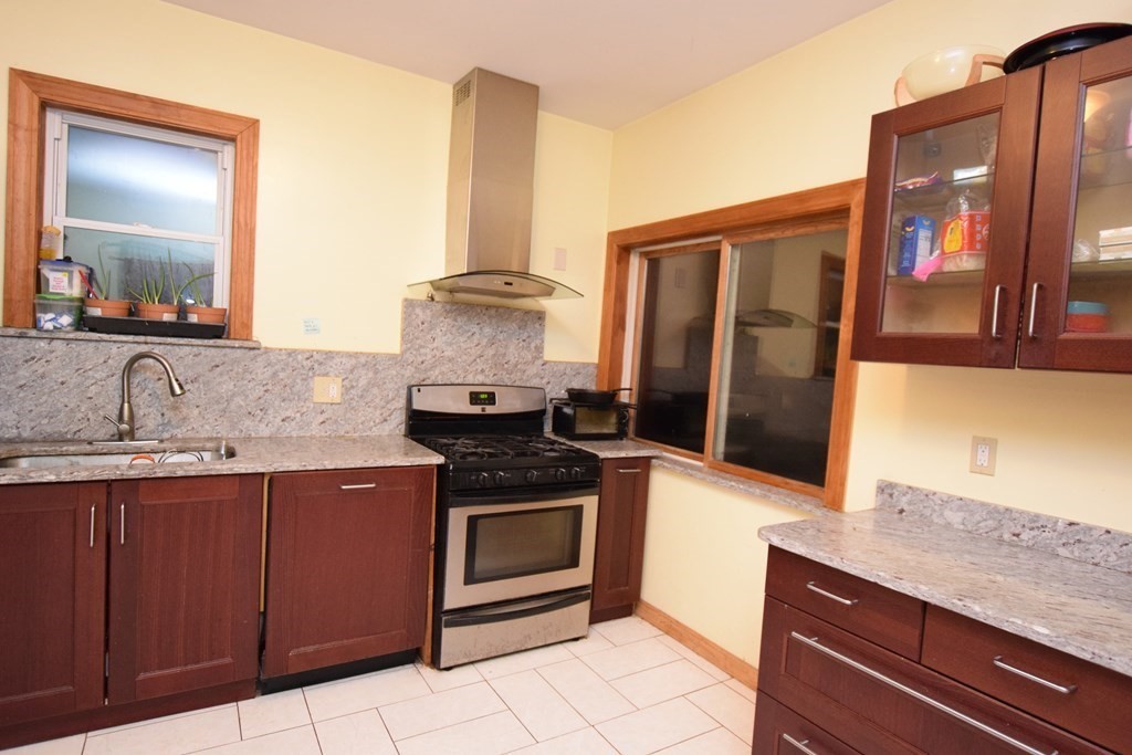 69 Deerfield Road Sharon, MA 02067 - Photo 2 of 12 a kitchen with a stove and a sink