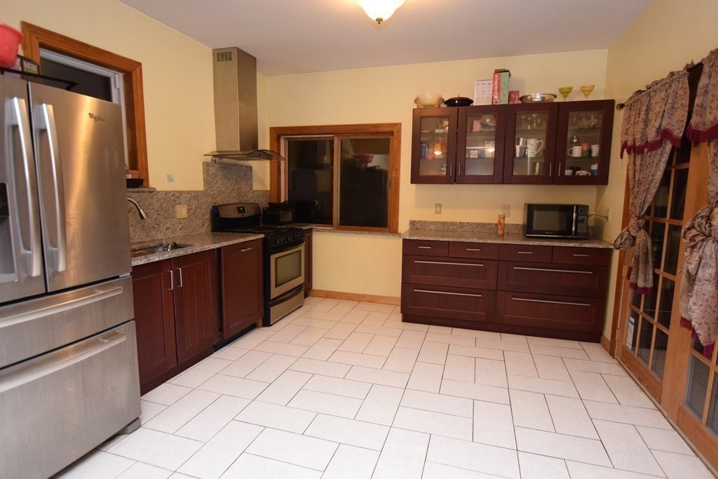 69 Deerfield Road Sharon, MA 02067 - Photo 3 of 12 a kitchen with stainless steel appliances a refrigerator and a counter space