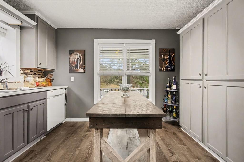 1932 River Bend Road Southwest Plainville, GA 30733 - Photo 11 of 30 a kitchen with a counter top space a sink cabinets and appliances
