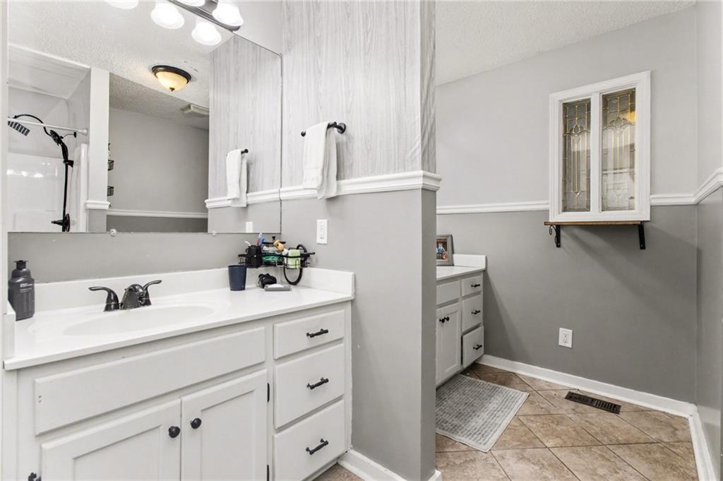 1932 River Bend Road Southwest Plainville, GA 30733 - Photo 14 of 30 a bathroom with a sink and a mirror