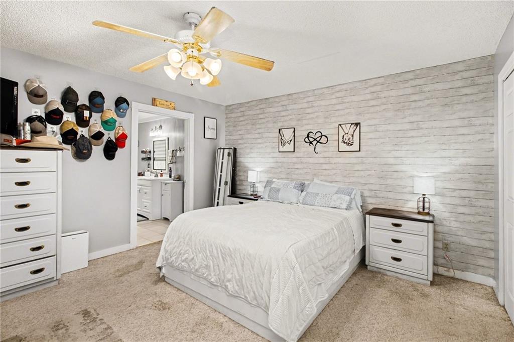 1932 River Bend Road Southwest Plainville, GA 30733 - Photo 16 of 30 a spacious bedroom with a bed and a cabinet