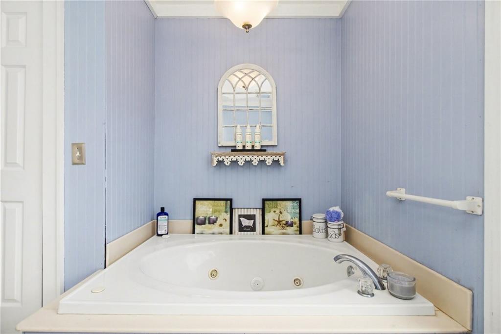1932 River Bend Road Southwest Plainville, GA 30733 - Photo 20 of 30 a bathroom with a bathtub and chandelier