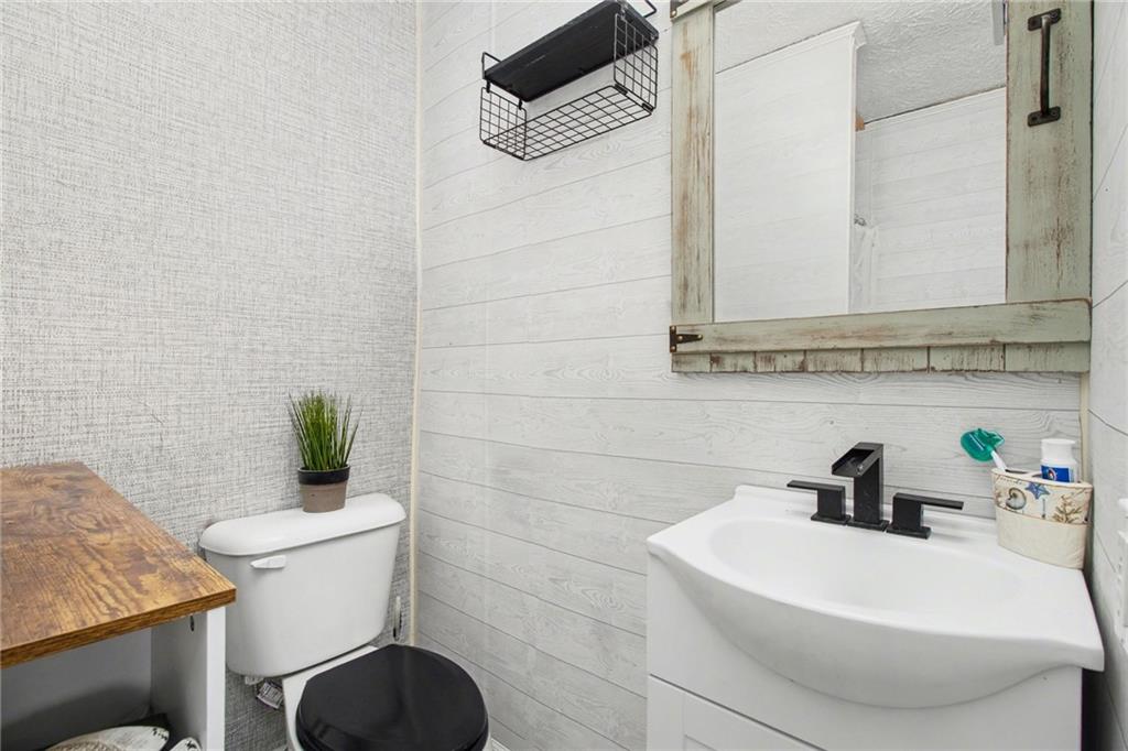 1932 River Bend Road Southwest Plainville, GA 30733 - Photo 23 of 30 a bathroom with a sink a toilet and mirror