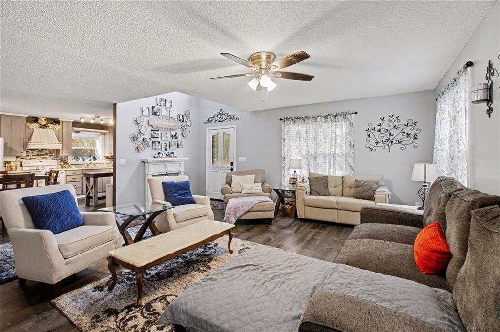1932 River Bend Road Southwest Plainville, GA 30733 - Photo 4 of 30 a living room with furniture and a chandelier