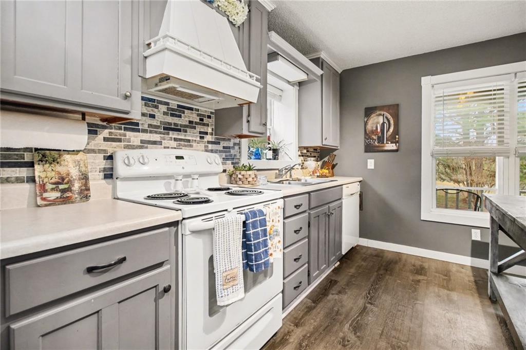 1932 River Bend Road Southwest Plainville, GA 30733 - Photo 10 of 30 a kitchen with stainless steel appliances a white stove top oven sink and cabinets