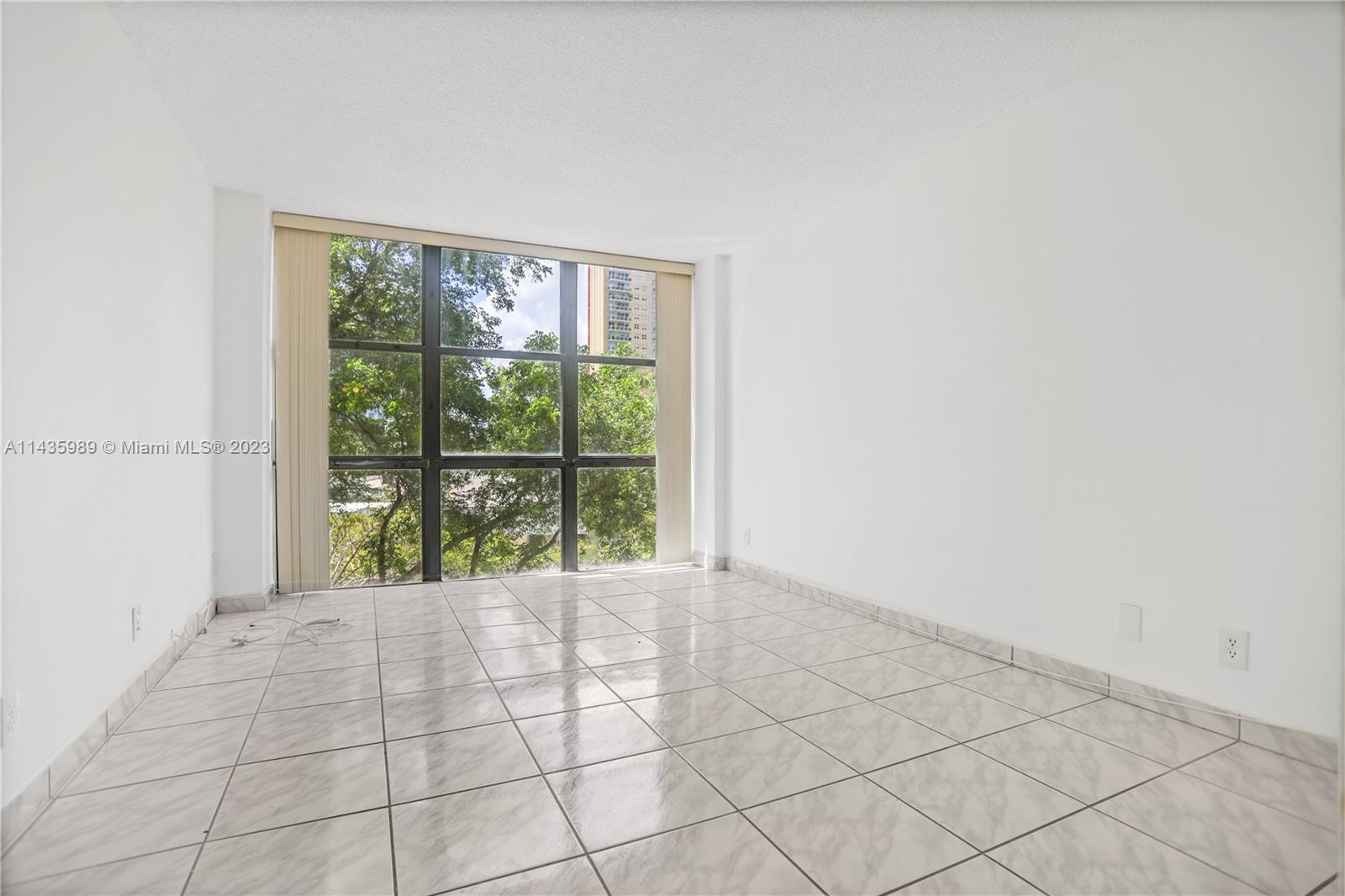 17021 North Bay Road, Unit 418 Sunny Isles Beach, FL 33160 - Photo 18 of 43 a view of an empty room with a floor to ceiling window