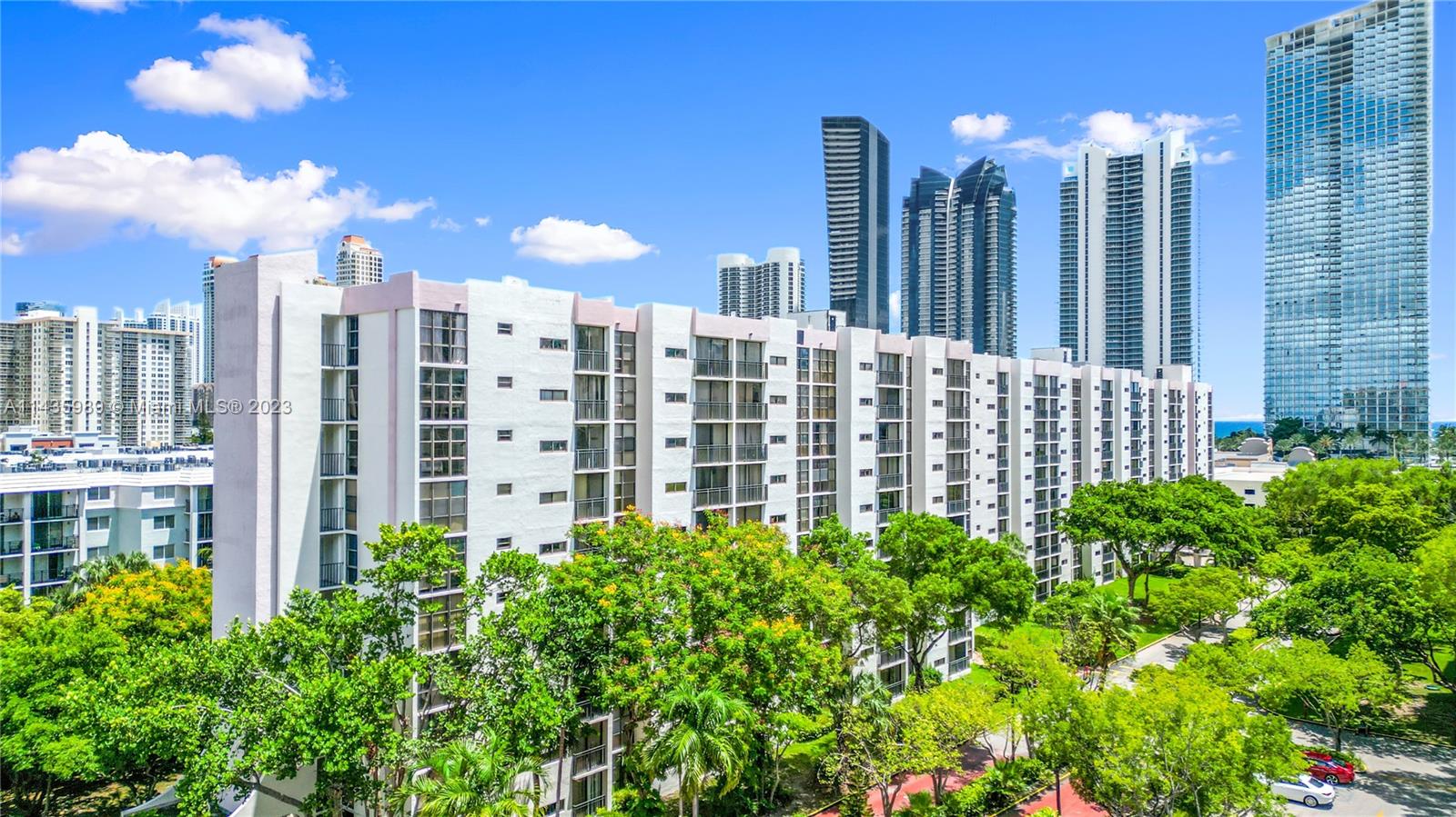 17021 North Bay Road, Unit 418 Sunny Isles Beach, FL 33160 - Photo 2 of 43 a view of a building with a garden