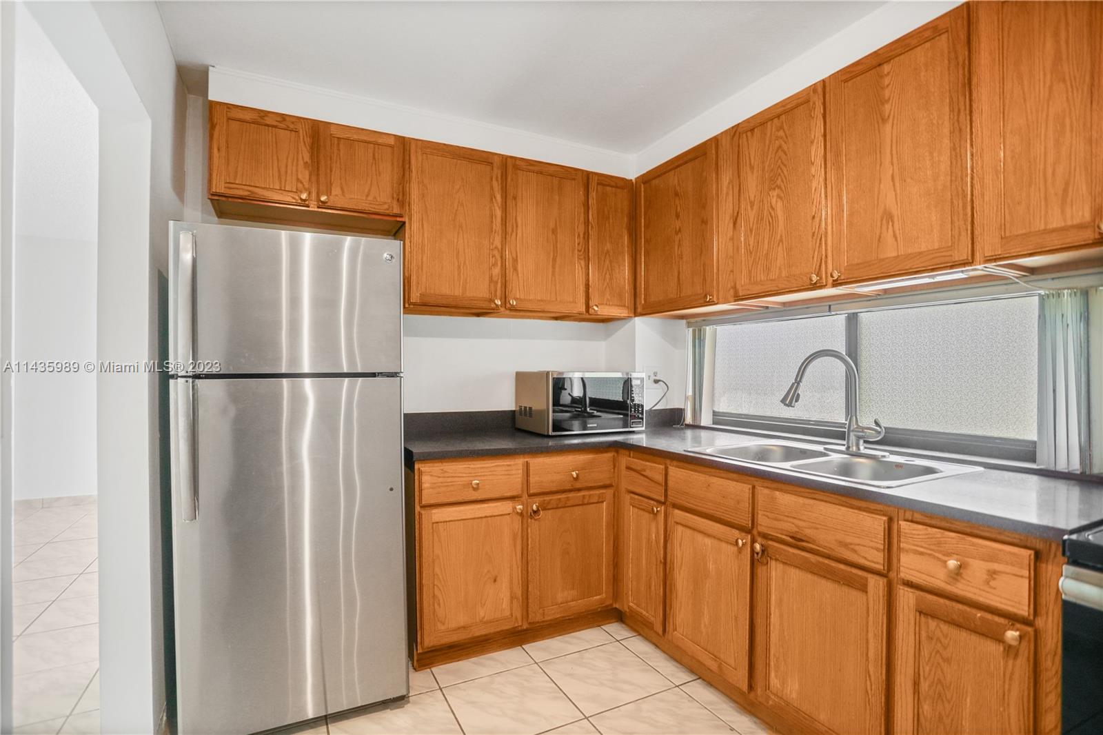 17021 North Bay Road, Unit 418 Sunny Isles Beach, FL 33160 - Photo 21 of 43 a kitchen with stainless steel appliances granite countertop a refrigerator sink and cabinets