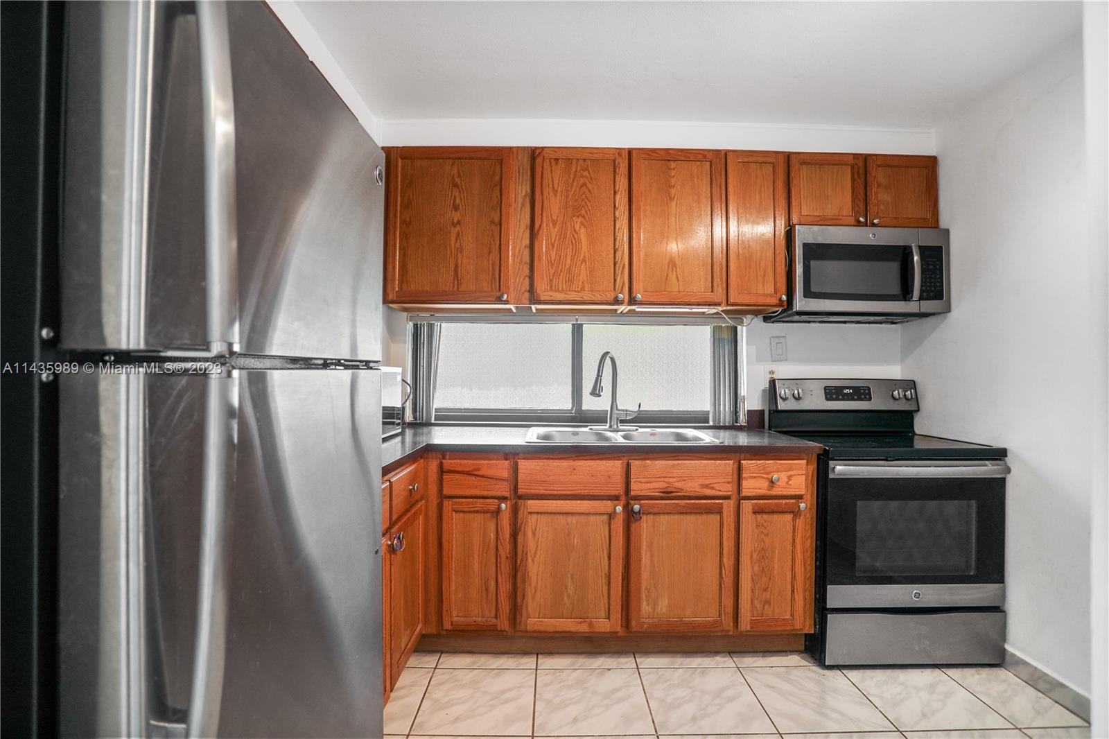 17021 North Bay Road, Unit 418 Sunny Isles Beach, FL 33160 - Photo 22 of 43 a kitchen with stainless steel appliances granite countertop a refrigerator and a stove top oven