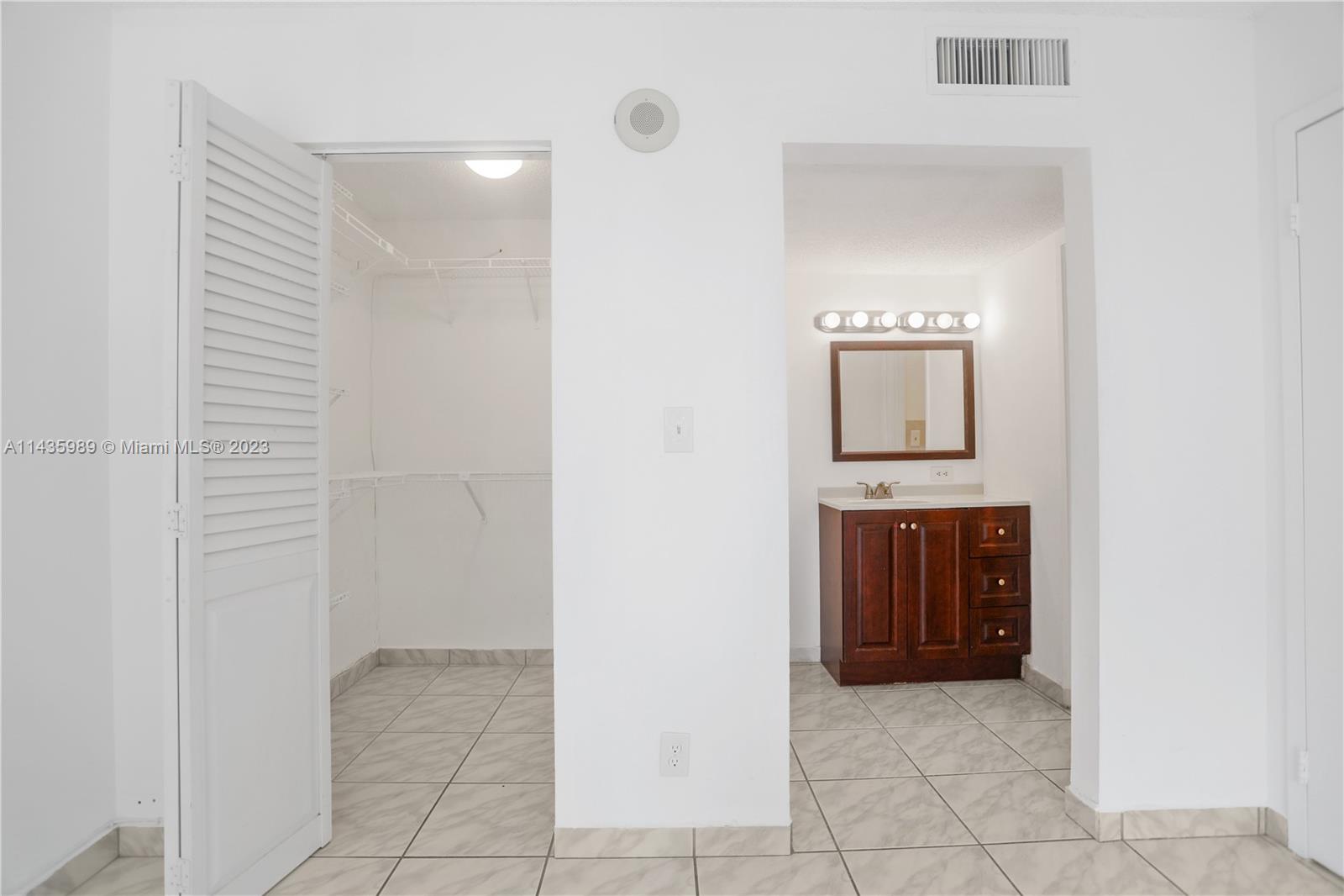 17021 North Bay Road, Unit 418 Sunny Isles Beach, FL 33160 - Photo 29 of 43 a bathroom with a sink and a mirror