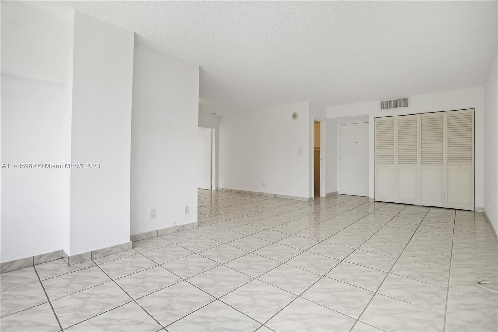 17021 North Bay Road, Unit 418 Sunny Isles Beach, FL 33160 - Photo 9 of 43 an empty room with a bench and cabinet