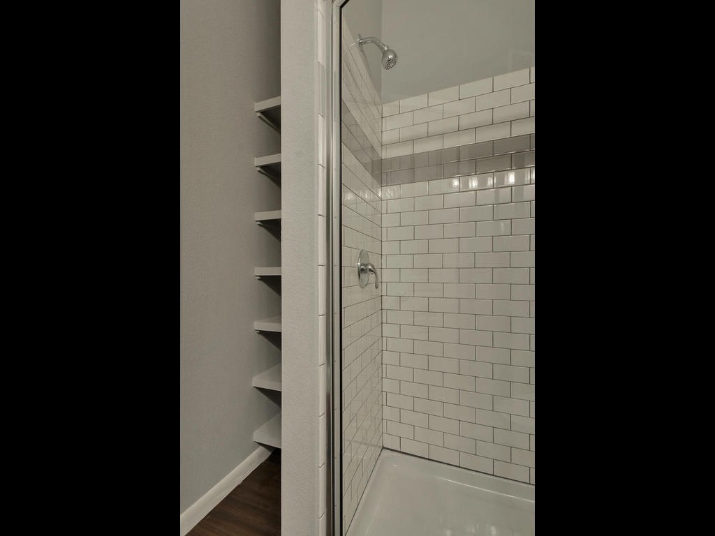 2822 Rio Grande Street, Unit 303 Austin, TX 78705 - Photo 19 of 26 a bathroom with a glass shower door