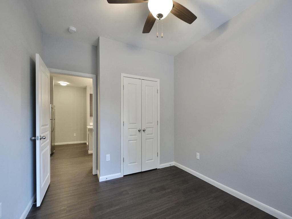 2822 Rio Grande Street, Unit 303 Austin, TX 78705 - Photo 10 of 26 an empty room with wooden floor and cabinet