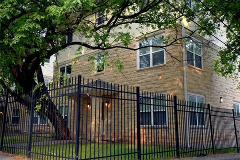 a view of a house with a iron gate