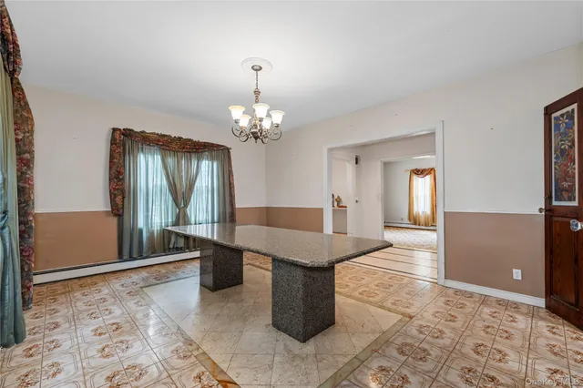 a spacious bathroom with a granite countertop sink a mirror and a bathtub
