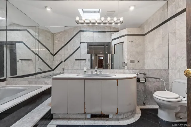 a bathroom with a sink a toilet and a mirror