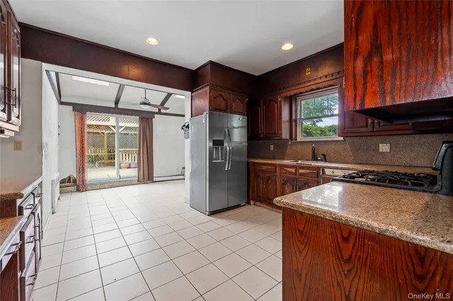 a kitchen with refrigerator and cabinets