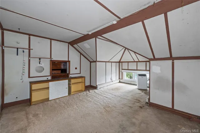 a view of a hallway with kitchen and wooden floor