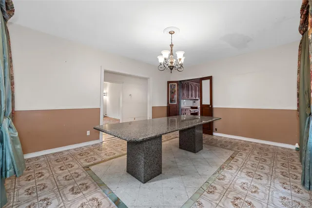 a dining hall with a dining table and chairs