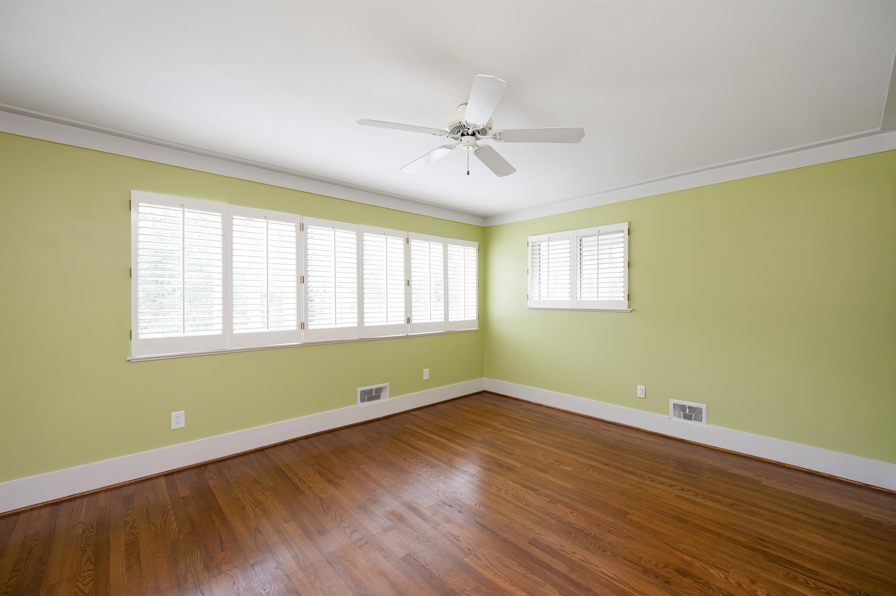 4907 Rembert Drive Raleigh, NC 27612 - Photo 24 of 52 Upstairs Bedroom with gorgeous hardwood floors, closet and windows with plantation shutters Upstairs Bedroom